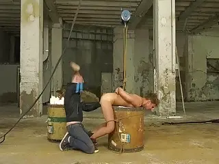 Bound BDSM twink has candle wax poured all over him