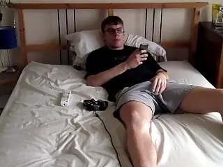 Geeky teen engages in masturbation while playing a video game